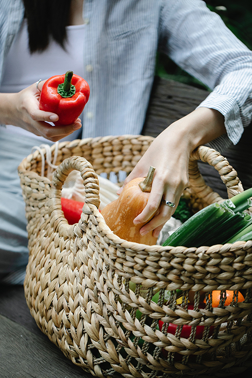 person unloading a basket of groceries